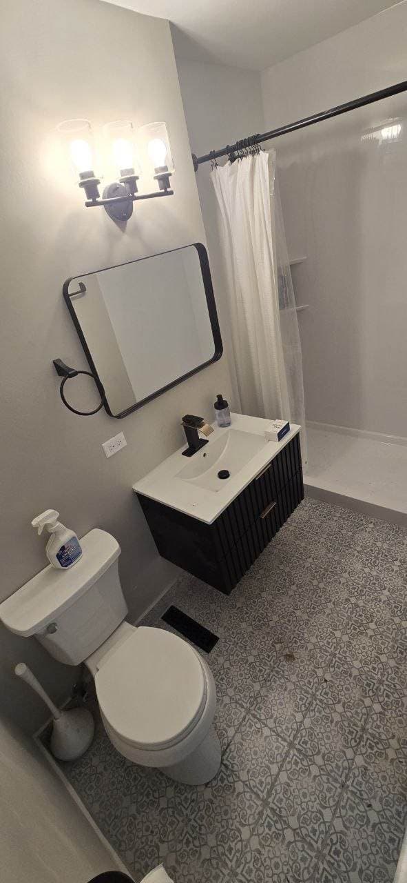 Patterned bathroom floor tile and vanity update completed by BAX in Hoffman Estates
