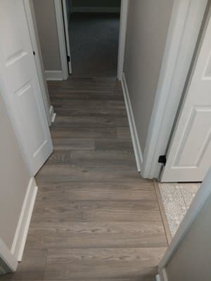 Close view of installed plank flooring and clean edge detail