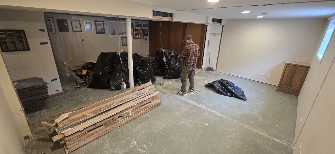 Basement floor cleared and prepared before laminate flooring installation by BAX