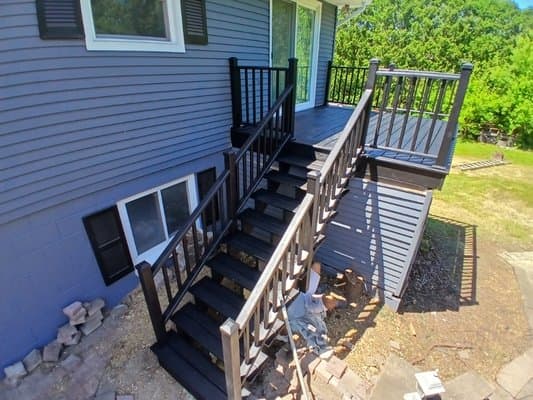 Remodeled dark wood deck and exterior stair railing