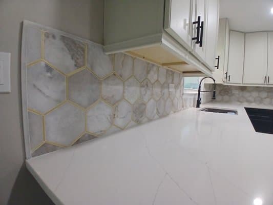 Detailed marble-look kitchen backsplash installed by BAX